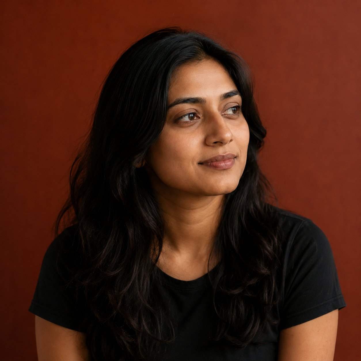 Priya, photographed against a terracotta background